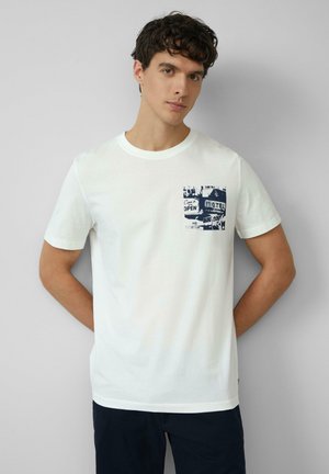 White cotton t-shirt featuring a navy graphic on the left chest pocket area. Round neckline, short sleeves, and a relaxed fit.