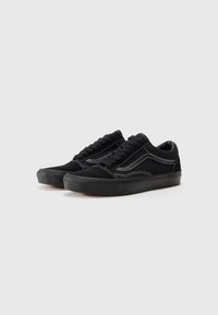 Black suede sneakers with a low-top design. Features white stitching and a textured rubber sole. Lace-up closure and rounded toe.