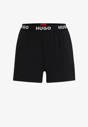 Zwarte boxershorts van zacht materiaal, voorzien van een elastische tailleband met "HUGO" in het wit gedrukt. Eenvoudig, strak ontwerp met een snit tot halverwege de dijen.