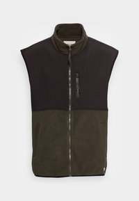 Uten ermer, glidelåsvest i svart og olivengrønn, med høy krage, glidelåslomme foran og mykt fleece-materiale. Teksturert todelt design.