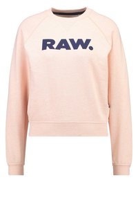 Světle růžová mikina s kulatým výstřihem a žebrovanými manžetami. Na hrudi se nachází výrazné tmavě modré logo "RAW.". Měkká, texturovaná tkanina.