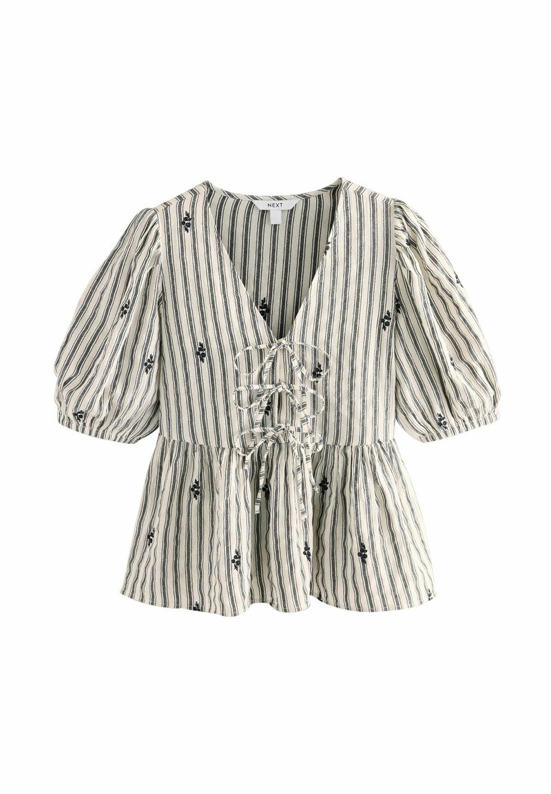 Haut en tissu rayé avec manches bouffantes, décolleté en V profond, détail à nouer au niveau de la poitrine, accents floraux noirs sur fond crème.
