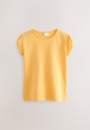 Kollane puuvillane T-särk ümmarguse kaelusega ja lühikeste puffy varrukatega. Omaduseks on sile tekstuur ja ühevärviline disain.