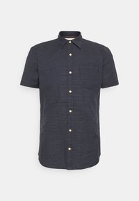 Camicia a maniche corte, blu navy, con un piccolo motivo a quadretti, unica tasca sul petto e bottoni dorati. Texture del tessuto liscia.