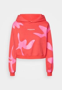 Sudadera recortada en un vibrante color coral con patrones abstractos rosas de gran tamaño. Presenta capucha, mangas largas y puños acanalados.