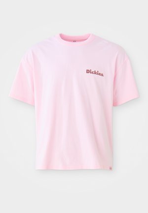 Light pink cotton t-shirt featuring a small brown "Dickies" logo on the left chest and short sleeves. Classic crew neck design.