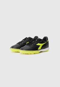 Black soccer shoes with yellow accents. Smooth leather upper, textured toe area, lace-up design, and structured outsole with rubber studs.