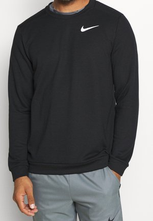 Sudadera negra de tela suave, con cuello redondo y mangas largas, presenta un logo blanco de Nike en la parte superior del pecho izquierdo.