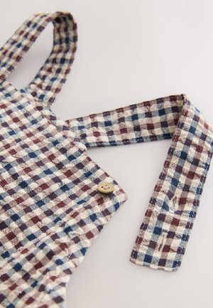 Ternede overalls i beige, blå og burgunder. Har justerbare stropper, en knappedetalje og et tekstureret vævet mønster.