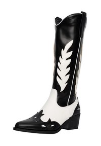 Botas de vaquero de cuero en blanco y negro con puntera puntiaguda, recortes decorativos y un tacón bajo. Presenta un diseño de hojas en el caña.