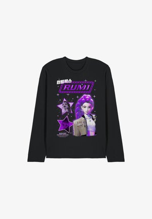 Black long-sleeve t-shirt featuring a purple graphic design, including a character with purple hair and star accents, plus text elements.