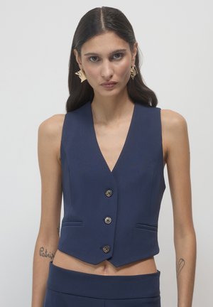 Navy blue sleeveless vest with a V-neck, five buttons, and two front pockets. Smooth fabric with a tailored fit and cropped hem.