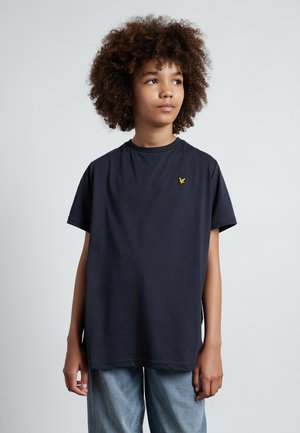 T-shirt in cotone blu navy con maniche corte, girocollo e piccolo logo di un'aquila gialla sul petto. Fit rilassato e design di lunghezza media.