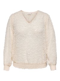 Krämfärgad långärmad blus med V-ringning, med texturerat blommönster och elastiska ärmslut och nederkant. Mjukt, lätt tyg.