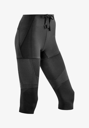Black athletic leggings with a high waistband, featuring textured panels and a drawstring. Made from stretchy, moisture-wicking material.
