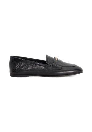 Black leather loafers with a flat sole, featuring a decorative strap and gold accents. The surface has a smooth texture with subtle creasing.