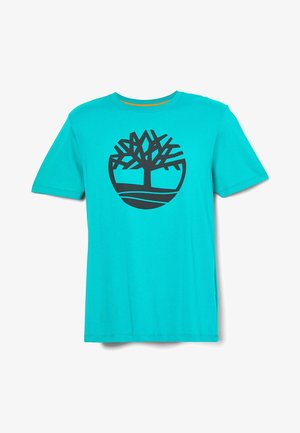 Turkusowy t-shirt z krótkim rękawem z czarnym abstrakcyjnym logo drzewa na środku klatki piersiowej.
