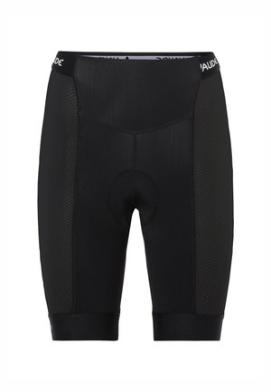 Zwarte fietsbroek van soepel materiaal met een textuur aan de zijkant, voorzien van een gevoerde zeem en een strakke tailleband.