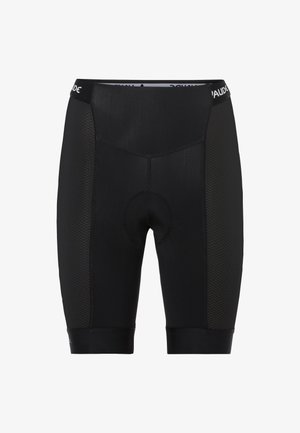 Zwarte fietsbroek van soepel materiaal met een textuur aan de zijkant, voorzien van een gevoerde zeem en een strakke tailleband.