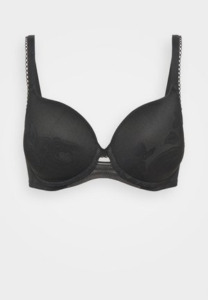 Reggiseno nero con coppe imbottite e lisce e motivo in pizzo floreale. Spalline regolabili con dettagli testurizzati e chiusura a gancio sulla schiena.