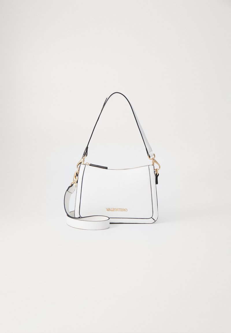 White handbag with black accents, gold hardware, and a structured design. Features a short top handle and a detachable shoulder strap.
