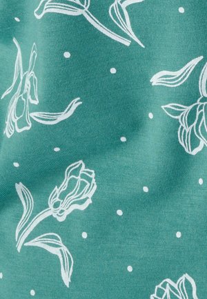 Tela verde azulado con patrón floral blanco y pequeños lunares; presenta formas de tulipanes con contornos definidos y textura suave.