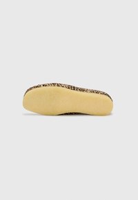 Leopard print shoe sole with a textured yellow rubber bottom. Features a rounded shape and a flat profile.