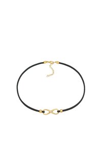 Sort snor choker med et guld uendelighedssymbol som midtpunkt og lille vedhæng, der har en tekstureret overflade og justerbar lås.