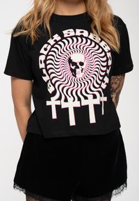 Black cropped t-shirt with swirling graphic featuring a skull and crosses in white and pink. Made of cotton, offering a soft texture.