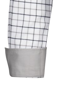 Tessuto bianco con un motivo a quadri nero e grigio; polsino grigio con una texture liscia; design sartoriale visibile all'estremità della manica.