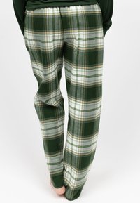 Pantaloni a quadri verdi e grigi con una consistenza morbida, caratterizzati da accenti bianchi e beige, una vestibilità dritta e una vita elastica.