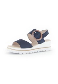 Navyblauwe wedge sandaal met een glad bovenwerk, open teen, ronde accent en een witte, gestructureerde zool. Verstelbare band voor een goede pasvorm.