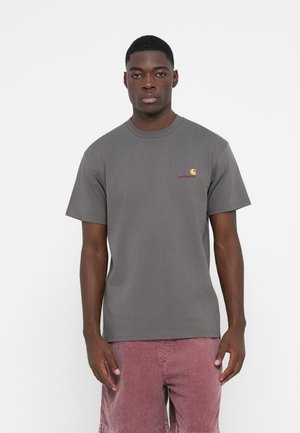 Gray cotton t-shirt with short sleeves and round neckline. Features a small embroidered logo in yellow and red on the chest.