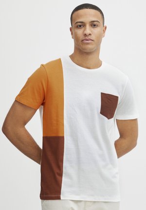 Color-blocked short-sleeve T-shirt made of cotton; features orange, white, and brown sections with a small chest pocket.