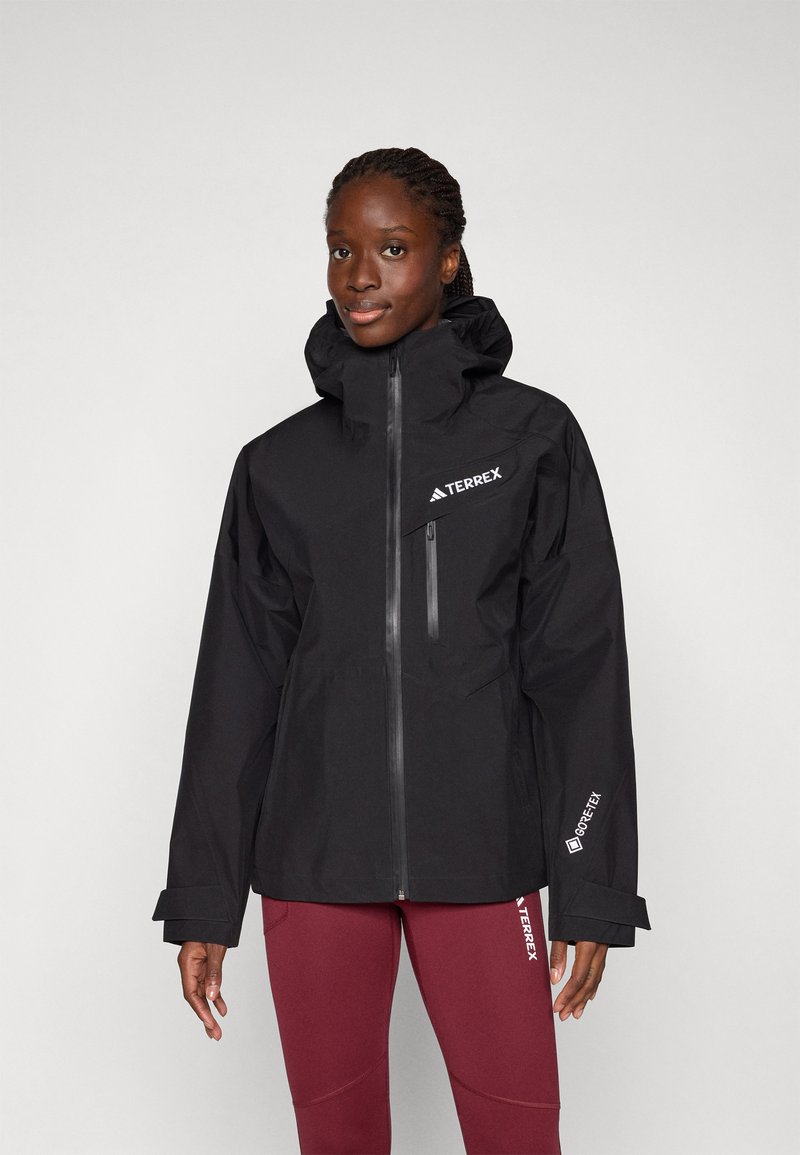 Schwarze wasserdichte Jacke mit hohem Kragen, Frontreißverschluss und Logo-Akzenten. Verfügt über ein elegantes Design und verstellbare Bündchen für mehr Komfort.