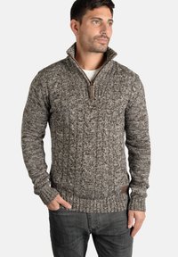 Cable-knit sweater in brown and gray tones, featuring a zip collar, ribbed cuffs, and hem, made from a textured knit material.