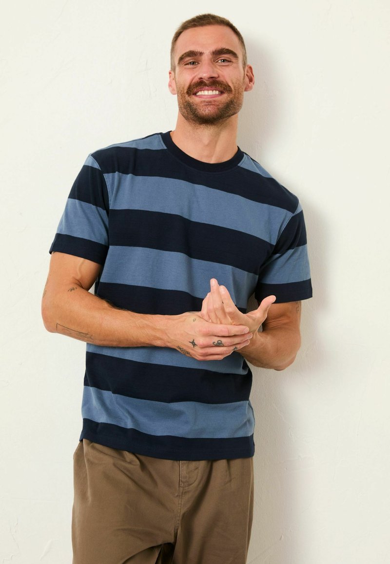 Marineblaue und hellblaue gestreifte T-Shirt aus Baumwolle, mit Rundhalsausschnitt und kurzen Ärmeln, lockerem Schnitt und glatter Textur.