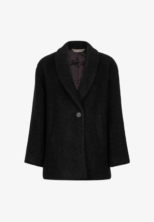 Manteau noir texturé avec un col châle, fermeture à un bouton, deux poches latérales et une doublure intérieure lisse. Adapté aux temps plus frais.