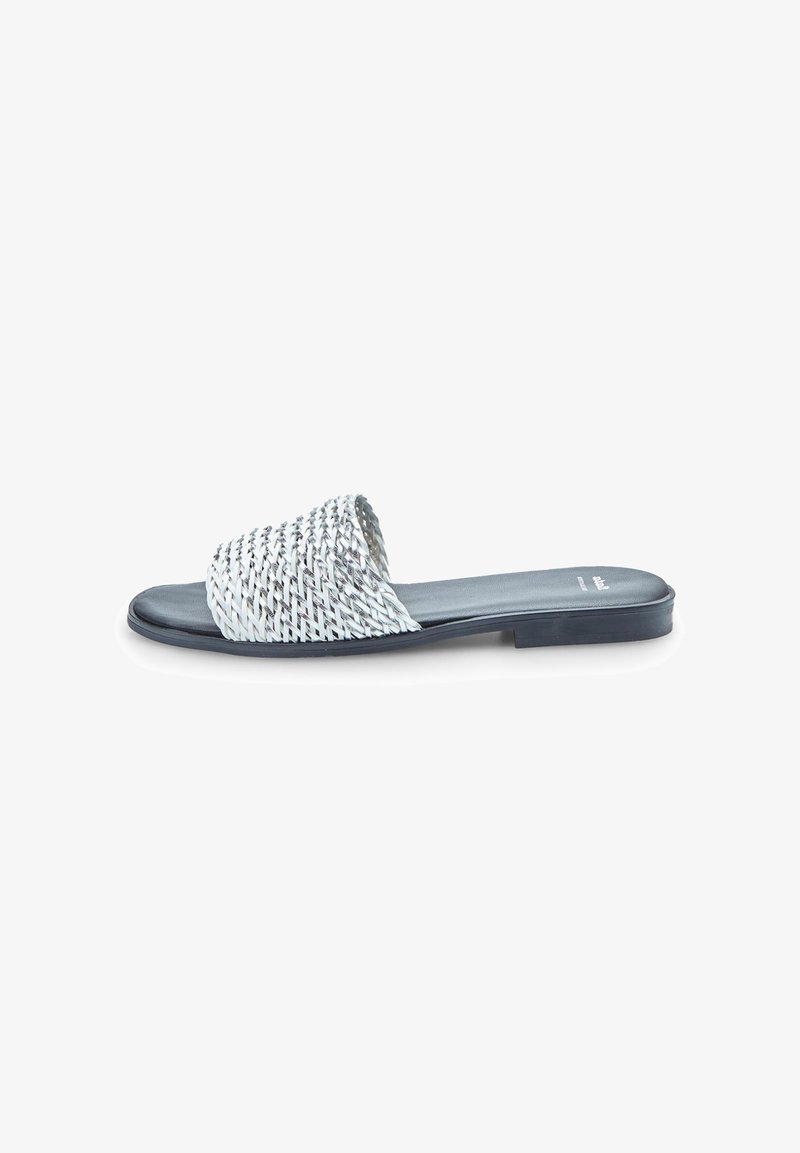 Woven slide sandal with a white and navy color scheme, flat sole, open toe, and textured strap. Smooth faux leather footbed.