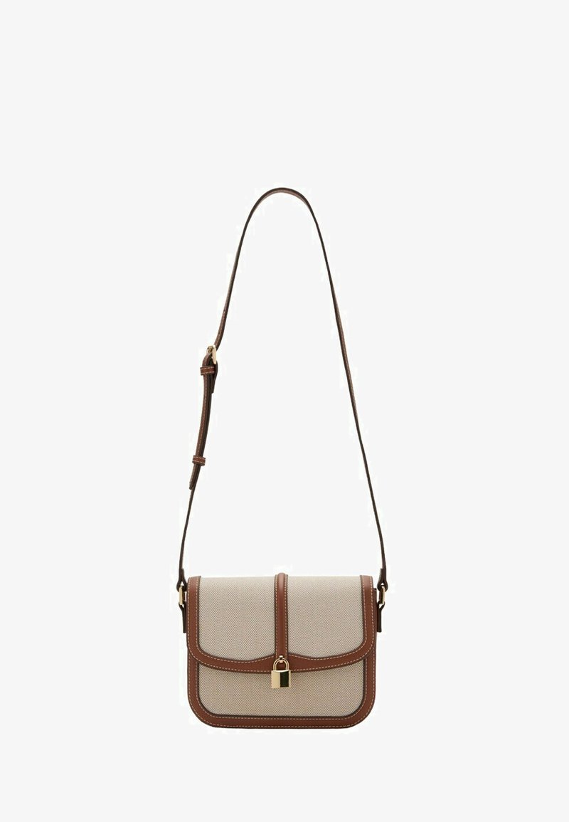 Beige crossbody bag with brown leather trim, adjustable strap, and front gold padlock clasp.