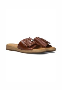 Brown leather slide sandals with a wide strap featuring a rectangular buckle, set on a light wood-toned sole and a tan footbed.