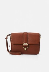 Brown leather crossbody bag with a textured finish. Features a flap with a gold accent ring and a detachable strap. Compact rectangular shape.