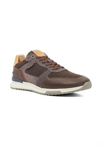 Brown leather and suede sneaker with beige accents, textured panels, rounded toe, and white rubber sole. Features lace-up closure and branding detail.