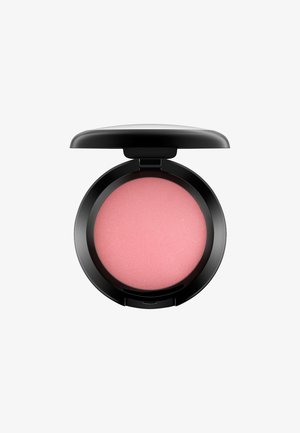 Blush compact with a black exterior. Features a round, light pink powder with a smooth texture and subtle ridged pattern.