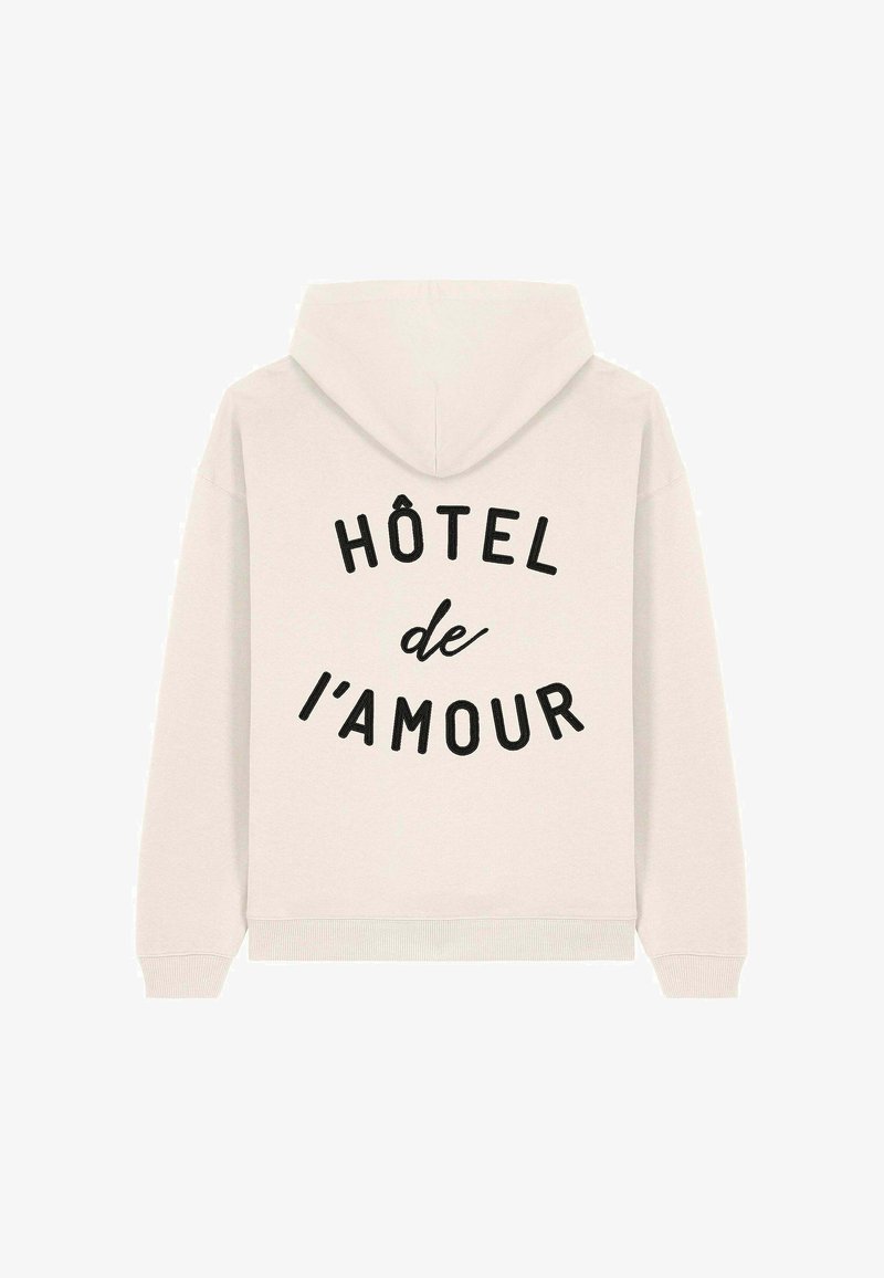 Svijetlosmeđi dukserica s opuštenim krojem, s crnim natpisom "HÔTEL de l'amour" u zakrivljenom dizajnu na leđima. Mekana tkanina.