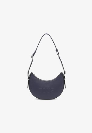 Navy blue crescent-shaped leather shoulder bag with embossed "TOUS" logo, silver hardware, and a single adjustable strap. Zipper closure.