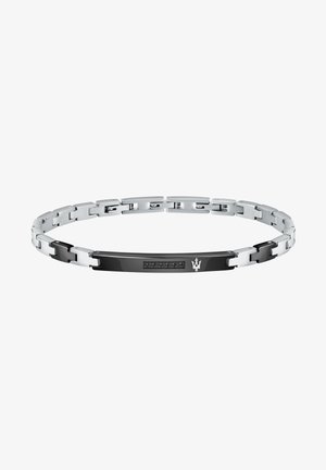 Silvrig och svart armband med sammanlänkade länkar, en slät yta och en rektangulär svart detalj med fem inbäddade stenar.