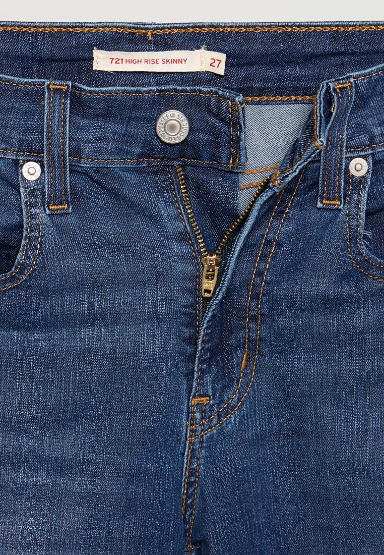 Dunkelblaue Jeans im Skinny-Stil mit hohem Bund, ausgestattet mit einem Reißverschluss, Metallknopfverschluss und Kontrastnähten. Die Größenangabe lautet 27.