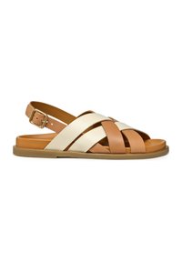 Sandalias de cuero en tonos beige y crema con tiras entrelazadas, correa ajustable en el tobillo y suela plana color beige. Textura suave y diseño minimalista.