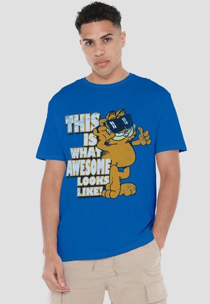 Blue cotton T-shirt featuring a graphic of a cartoon cat wearing sunglasses, with bold, textured white and yellow lettering.
